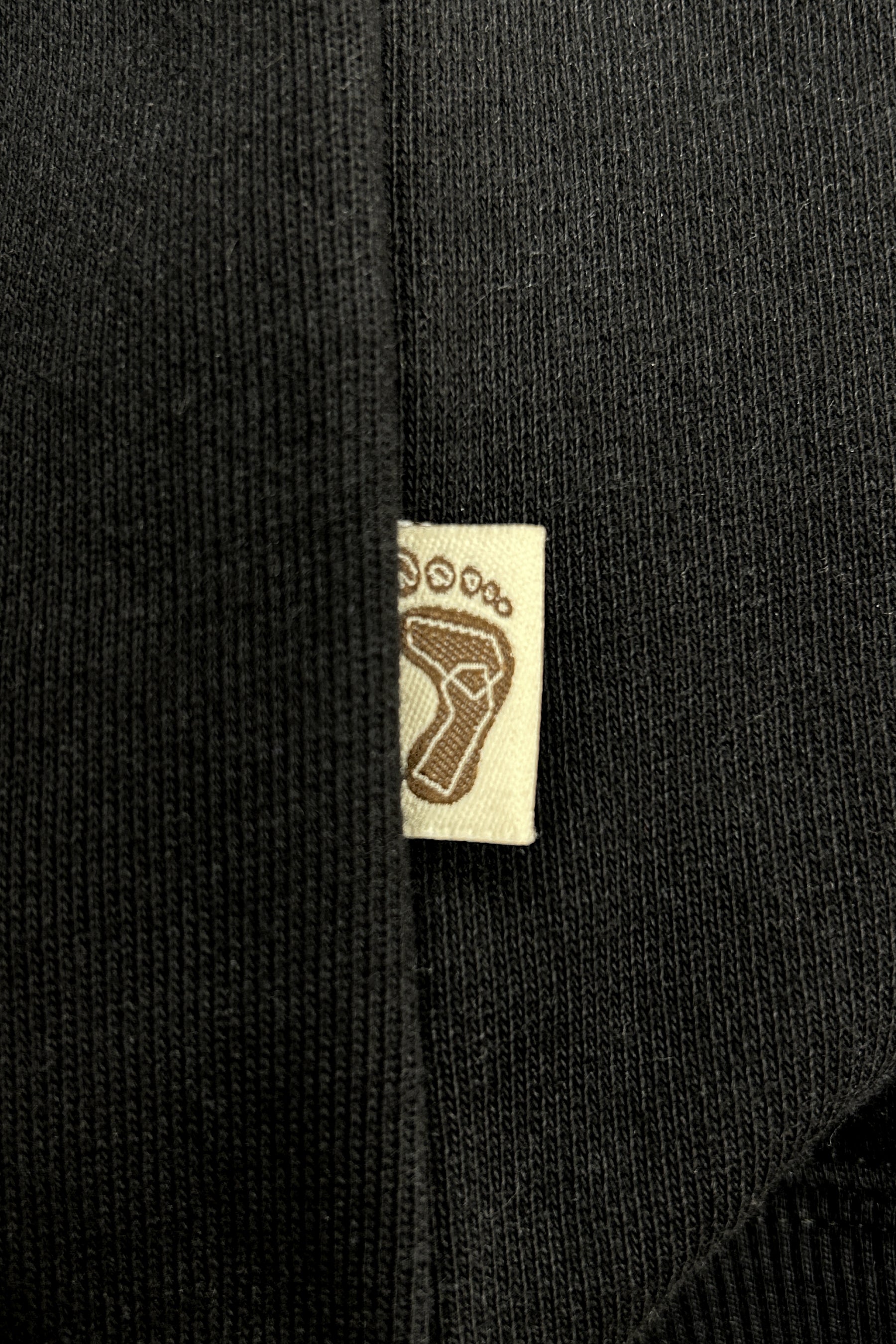 Tag-up of 16 Sixteen embroidered logo on TRIBE WEAR zip-up hoodie