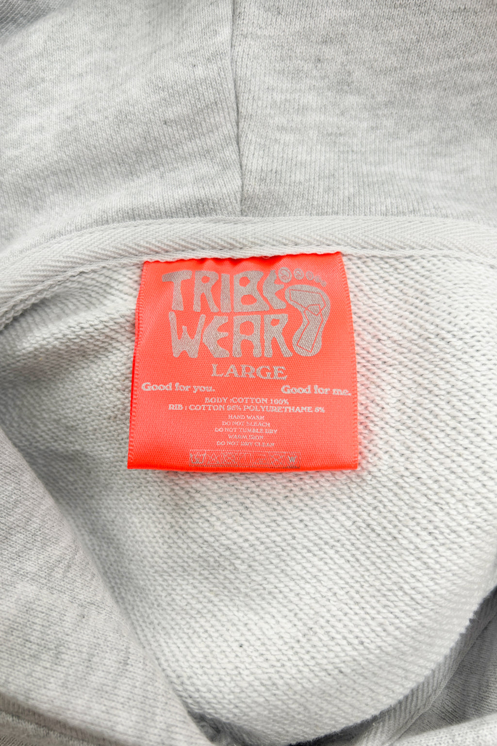 Tag-up of 16 Sixteen embroidered logo on TRIBE WEAR zip-up hoodie